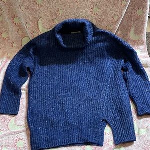Oversized high fold over neck blue sweater. Has matching slits on one side.